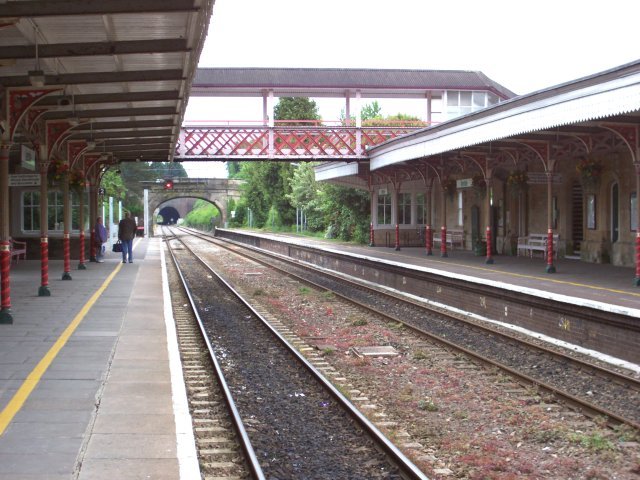View south toward Minety and Swindon from the eastern - Up - platform of Kemble station. The points at the end of this platform lead to the stump of the former GWR branch line to Cirencester Town and Kemble Tunnel - carrying the A429 trunk road - is visible beyond the bridge carrying the minor road to Tarlton.
