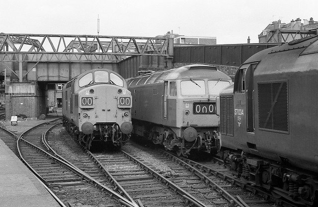 n fact the 25 July 1976 picture above shows 37 034 in the company of 37 026 and 47 038 at the country end of Liverpool Street with the shunter's cabin and first floor crew messroom visible under the girder bridge carrying Pindar Street EC2A.  The sidings, girder bridge and taxi ramp to the right have all since disappeared during redevelopment of the station, now served by electric multiple units rather than locomotive hauled trains.