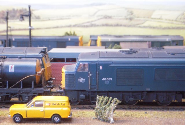 Eastgate was a typical 1970s London Midland Region motive power depot servicing locomotives from nearby marshalling yards - and even the odd visiting Deltic! The layout was built around Peco Code 100 Streamline track, a fully lit Peco motive power shed, Dapol figures and Knightwing fuelling point.  Of particular interest were the yellow British Rail van and lubricating oil tank wagon - seen next to 46 053 below - and 08 402 propelling NDV M84281 toward the pair of Class 20s in the picture above.  Notice that both the English Electric  350 bhp 0-6-0 and the 1957 vintage Pressed Steel Gangwayed Brake Van have doors opened inward!