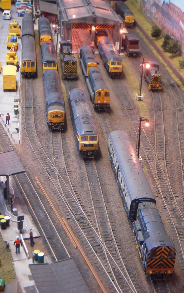 Eastgate was a typical 1970s London Midland Region motive power depot servicing locomotives from nearby marshalling yards - and even the odd visiting Deltic! The layout was built around Peco Code 100 Streamline track, a fully lit Peco motive power shed, Dapol figures and Knightwing fuelling point.  Of particular interest were the yellow British Rail van and lubricating oil tank wagon - seen next to 46 053 below - and 08 402 propelling NDV M84281 toward the pair of Class 20s in the picture above.  Notice that both the English Electric  350 bhp 0-6-0 and the 1957 vintage Pressed Steel Gangwayed Brake Van have doors opened inward!