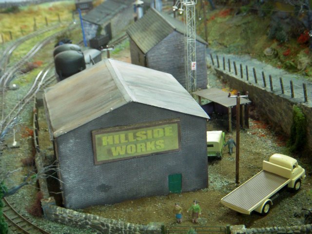 Constructed using Peco 009 proprietary track and a large amount of modeller's licence, the portable yet entertaining layout depicting fictional Hillside Works was set on the Welsh Borders during autumn in the late 1960s and early 1970s. However, long term plans are to bring it up to date as a preserved railway - Hillside Works Heritage Centre - complete with working vintage machinery, and tourist cafe. 