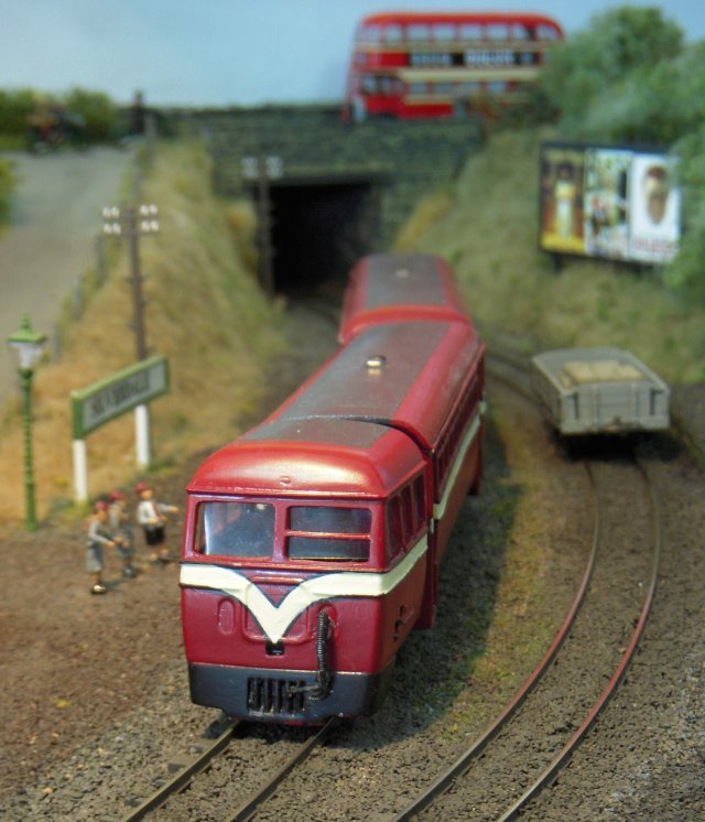 Arriving at under the palm trees at Ballamodha station above is Manx Northern Railway 0-6-0T Number 4 "Caledonia" built by Dubs and Company of Glasgow in 1885 while - below - one of the ex County Donegal railcars which arrived on the Isle of Man in 1960 passes through Silverdale with an Isle of Man Road Services Leyland PD1 double deck bus passes behind it.