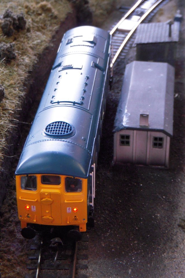 The Coal Yard represented a small corner of a colliery with a working loader, allowing a train of empty wagons to arrive from the exchange sidings and for the railway company locomotive to be uncoupled before a colliery shunter propelled them under the loader.  The full wagons were then returned to the siding they had arrived on, the shunter retired to its own engine shed and the train engine re-attached to take them away.