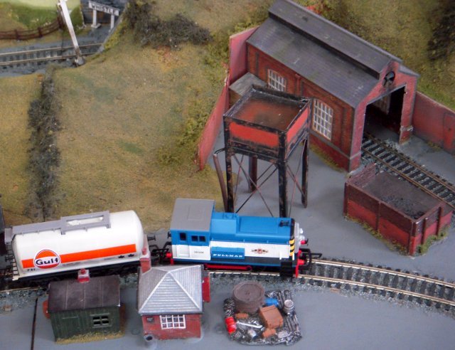 Tank wagons rather than tank engines were to the fore on this outing, marshalled behind a Pullman liveried Class 06 diesel next to a very neat pile of tools and components.  However, passenger traffic was still being drummed up by the display of nostalgic holiday posters visible from the station platform on the back of the signalbox.