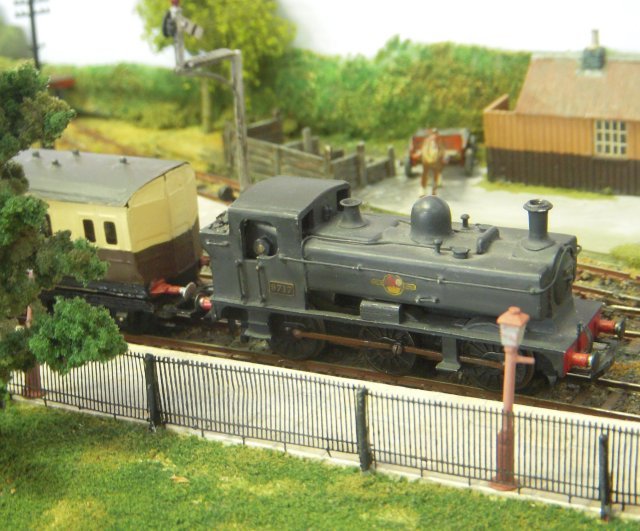This fictitious 1950s layout was based on the concept that the Midland & South Western Junction Railway continued as a secondary route through the Cotswolds despite the Great Western Railways endeavours to rationalise it during previous years.  Trains of former LMS and GWR stock could thus be seen on the 11'6" long by 20" scenic section between fiddle yards.