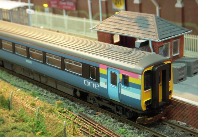 This layout was inspired by a visit to Cromer in 2005 - and a further mission to measure and take photographs in August 2008 - and included Morrisons' supermarket, part of the original station building which is now a pub, a very stylistic house opposite the signalbox and and the redundant signalbox itself: the last one to be built from concrete blocks cast at the Midland & Great Northern Joint Railway works at Melton Constable and now preserved as a museum of signalling. The platform length and width were reduced a little and although the cutting length was accurate as far as the crossovers, it was very much foreshortened to the bridge in order to keep the layout to a reasonable length.  The track was Peco 100 with minimum radius points (rather than large radius due to space constraints) and the plain track had sleeper spacing increased to improve appearance.