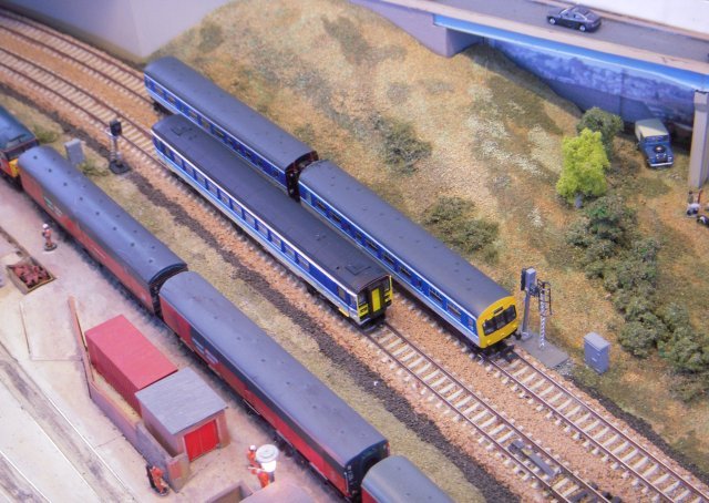 Now that Barton Hill - originally built more than five years ago by Don Dickson of Nailsea & District MRC - is owned by Stan Potter the trompe d'oeil elevated road bridge has been extended into a third dimension to carry model vehicles and new buildings and working lights have been fitted to the depot itself.