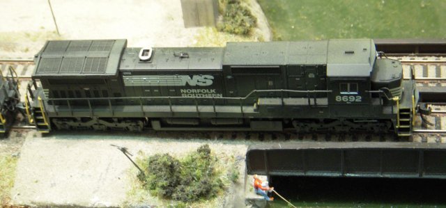 First built for Union Pacific in the late 1980s by General Electric,  DASH 8-40C diesel electrics like Norfolk Southern's 1990 vintage 8692 pictured above were identified by an enlarged exhaust stack and the mounting of the dynamic brake grids in a quadrilateral unit behind the cab, which housed an enlarged equipment blower fan. These six-axle, 4,000 hp engines are still in service today in North America.