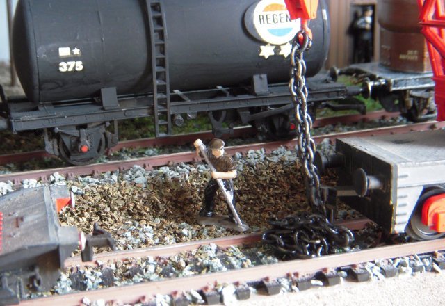 Nodding back to my Wagon Repairs diorama, now on display at the Dean Forest Railway in Norchard, was a coal office at the end of a siding below some other tracks and the picture above shows the different levels of this Dapol themed diorama as well as some of the scenic material used.  The grey ballast and fine earth were "as bought" while the grass was my own mixture first used on the earlier Square Airfield diorama and the coarser brown  - seen below by the black painted chain used to tension the crane hook cabling - was in fact tea leaves unused and past their use-by date.