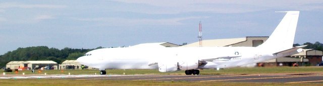 Catching a burst of sunlight at the eastern end of Fairford's runway was the plain pale anti-flash livery of United States Navy Boeing E-6B Mercury 162782. Like the Transall C-160H Astarte described above, the E-6 Mercury was developed from earlier Lockheed EC-130Q aircraft both to relay communications from the US Navy's National Command Authority to its nuclear submarines and to become directly responsible for the ballistic missile carrying fleet at sea if the established land based command structure was disrupted.  Such a mission profile is known as TACAMO - Take Charge and Move Out.