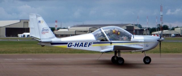 One of the joys of visiting an air display is having your knowledge stretched by unfamiliar types, such as G-HAEF, a Czech Republic built Evektor EV-97 Eurostar ( constructor's number 3322 ) owned by RAF Halton Microlight Club and bearing the legend "Royal Air Force Charitable Trust" on the duralumin fin.  Other parts of the low wing fixed-undercarriage nosewheel single propeller two-seater are made of composite material.  A choice of 80 or 100 bhp four cylinder four-stroke Rotax engines can be installed to turn a fixed pitch two blade wooden propeller and folding wings for minimal hangar storage are an option.
