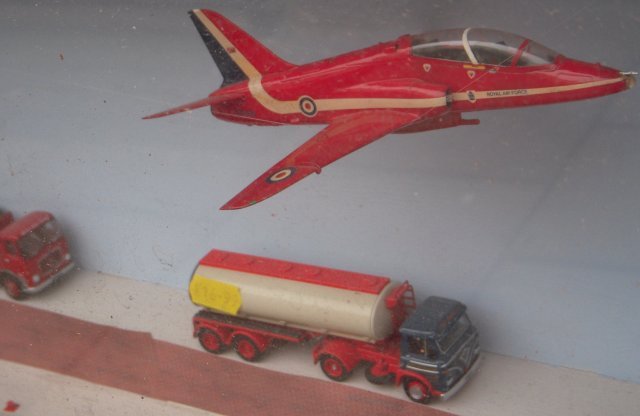 Like the P1127 discussed above - but unlike the Gnat and Vampire - Red Arrows liveried XX306 has horizontal tail surfaces set markedly higher on the fuselage than the wings which, in the context of the two Flightline suspension filaments, gives a pleasant nose-up climbing attitude: not least because this 1/72 scale model has been completed with the Hawk's optional fuselage centreline weapons training gun pack and it would not be wise for the 30mm ADEN canon to be pointing at civilian road vehicles even if it did match the rest of the Rolls Royce Adour powered trainer!