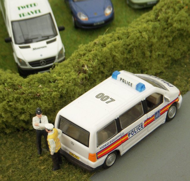 Just up the lane from this breach of the Highway Code, two Bachmann police officers were having a conversation next to their Mercedes people carrier although spectators might have noticed that the video-equipped vehicle was left hand drive, revealing its Continental origins.  Just over the hedge in another field meanwhile was Vincent's own right hand drive Mercedes minibus in the Code 3 markings of Tweed Travel and named after his good lady wife Maureen.