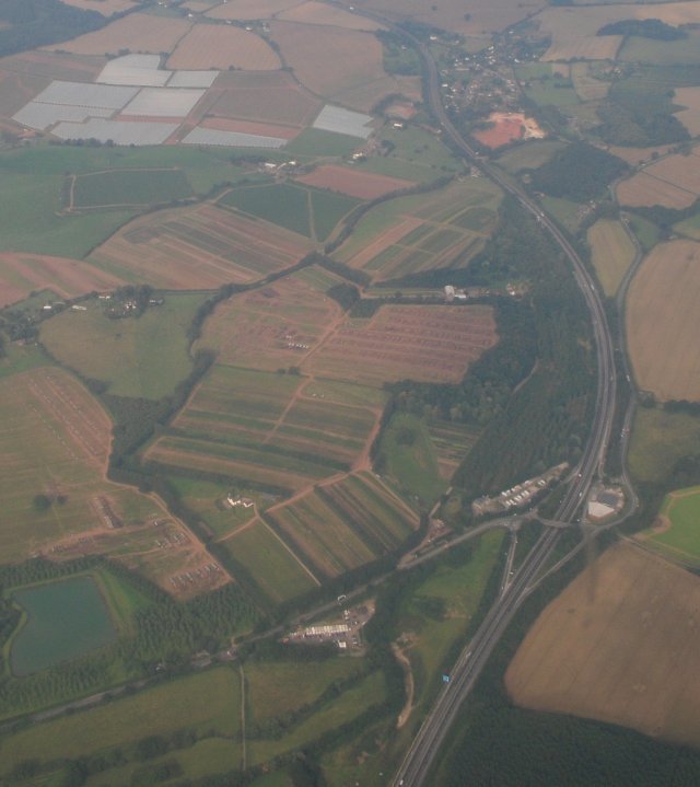 The passengers having been pushed back into their leather seats by the acceleration of take off, NM601 then took a north westerly course from Staverton, allowing me to take the picture above of Junction 2 of the M50 motorway, looking west towards Ross on Wye with the A419 approaching from the South and then leaving the frame towards the top right hand corner.  Also visible from this altitude were the large areas of crop being cultivated nearby under glass.