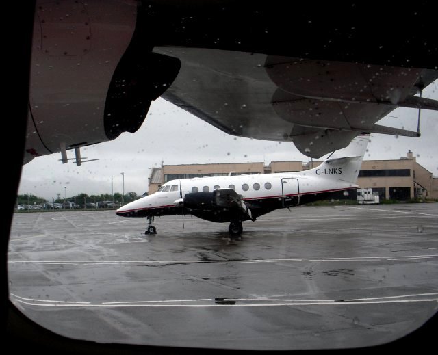 Having crossed the North Welsh coast near Colwyn Bay however, Flight NM601 then encountered the rain that enfolded the Isle of Man that day - in contrast to the fair weather that Gloucestershire was enjoying.  Despite this however - and my ears feeling like they had been stabbed with Stanley knives - D-ILKA touched down at Ronaldsway Airport ahead of schedule, permitting views of G-LNKS, BAe Jetstream 31 "Connie May" of Humberside based Links Air Service (above, from inside D-ILKA) and of Aer Lingus's ATR 42-300 EI-CPT (bearing the Franco-Italian constructor's number 191). Also pictured below from the Arrivals side of the terminal was De Havilland Canada DHC-8-402Q Dash 8 G-FLBA of Exeter based Flybe, Europe's largest regional airline which evolved from Jersey European Airways.