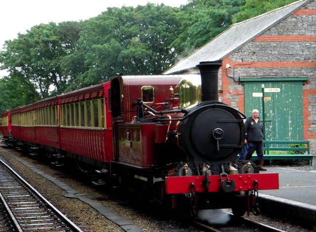 the eventual 1220 departure to Port Erin was hauled by 12 "Hutchinson", one of four "medium boiler" Isle of Man Railway locomotives - numbered 10 to 13.  Compared to 7 "Tynwald",  their boilers were enlarged from 2'11" diameter to 3'3" and pressurised to 160 psi giving a 20% increase in power output. Locomotives 10-13 were also built with 480 gallon water tanks although cylinder and driving wheel dimensions were unchanged.