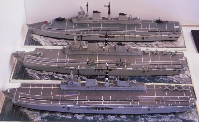 Less mysterious but just as controversial at the end of their careers were models of  three Royal Navy ships that started life being known as "through deck cruisers" - HMS Ark Royal (R07, nearest the camera) HMS illustrious (R06, middle) and HMS Invincible (R05, top of picture), represented at different stages of their careers.