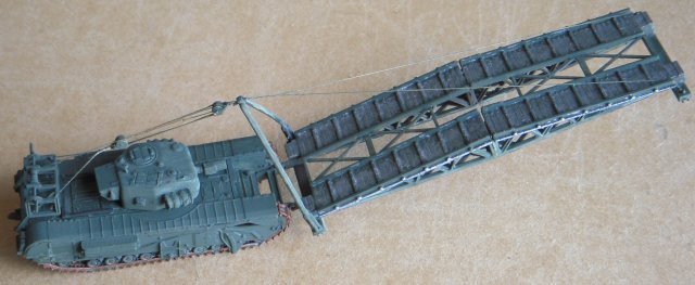 The Dieppe raid of 1942 failed with heavy losses of both armour and infantry because tanks were unable to penetrate inland.  To overcome or destroy obstacles during future landings, J.J.Donovan of the Royal Canadian Engineers suggested a tank that could launch a small box girder as a bridge or a ramp and the Churchill Mark IV was chosen for this project due to its roomy hull with side doors for loading stores and equipment.  