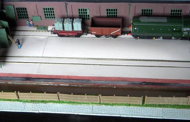 In the 1950s British Railways made the first major attempt at the bulk transit of cement with its L-type container. Loaded at the top and discharged from the bottom the cube-like L-types had a tare (or unladen) weight of around 12 cwt each and could carry 4 tons of cement within a 90 cubic foot capacity. They were painted grey with white lettering on black panels and travelled three at a time on dedicated four wheeled vacuum braked wagons known as Conflat Ls. These wagons – many built to Diagram 1/066 – had holes in their floors to allow the L-type containers to be gravity discharged without unloading.