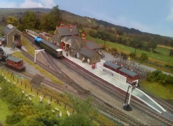 A Western Region country terminus on the Devon/Cornwall border. The local creamery provides milk for Bristol and the small but busy goods shed keeps inward and outward traffic moving. The local coal merchant also has a siding.